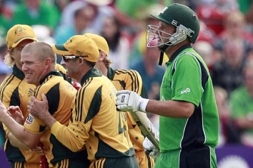 James Hopes celebrates with teammates after dismissing Peter Connell.